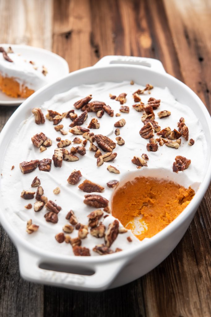 sweet potato casserole with coconut whipped cream topped with maple and cinnamon pecans