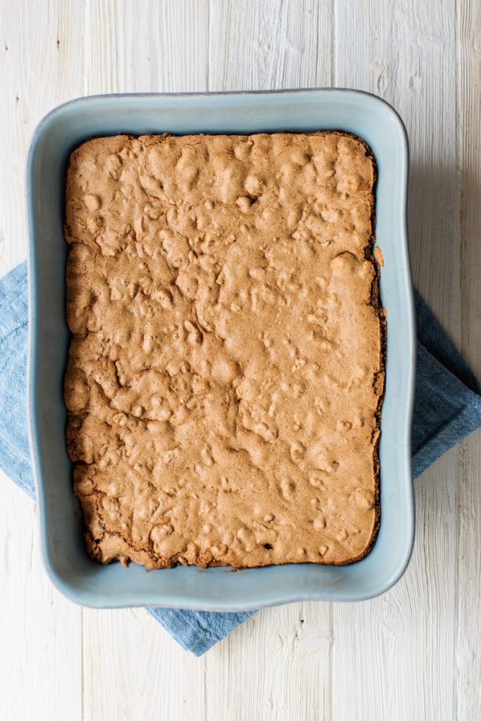 freshly baked walnut bars in a blue baking dish