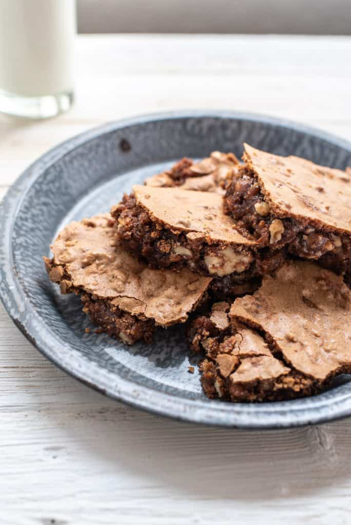 brown sugar walnut bars on a blue plate with a glass of milk