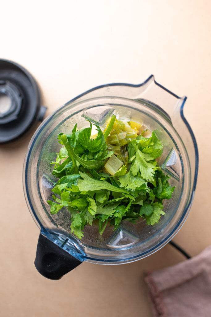 celery soup in the blender with celery leaves