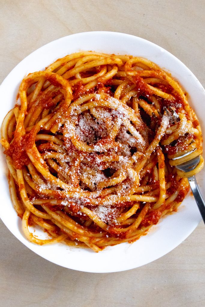 bucatini with butter roma tomato sauce in bowl