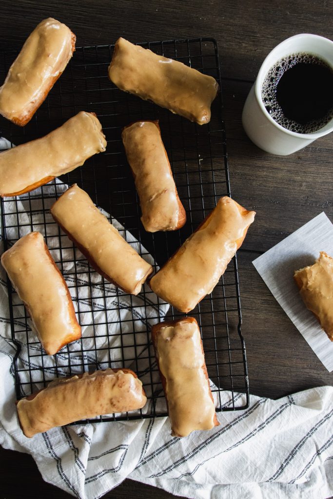 long john donuts dipped in maple icing on a serving tray