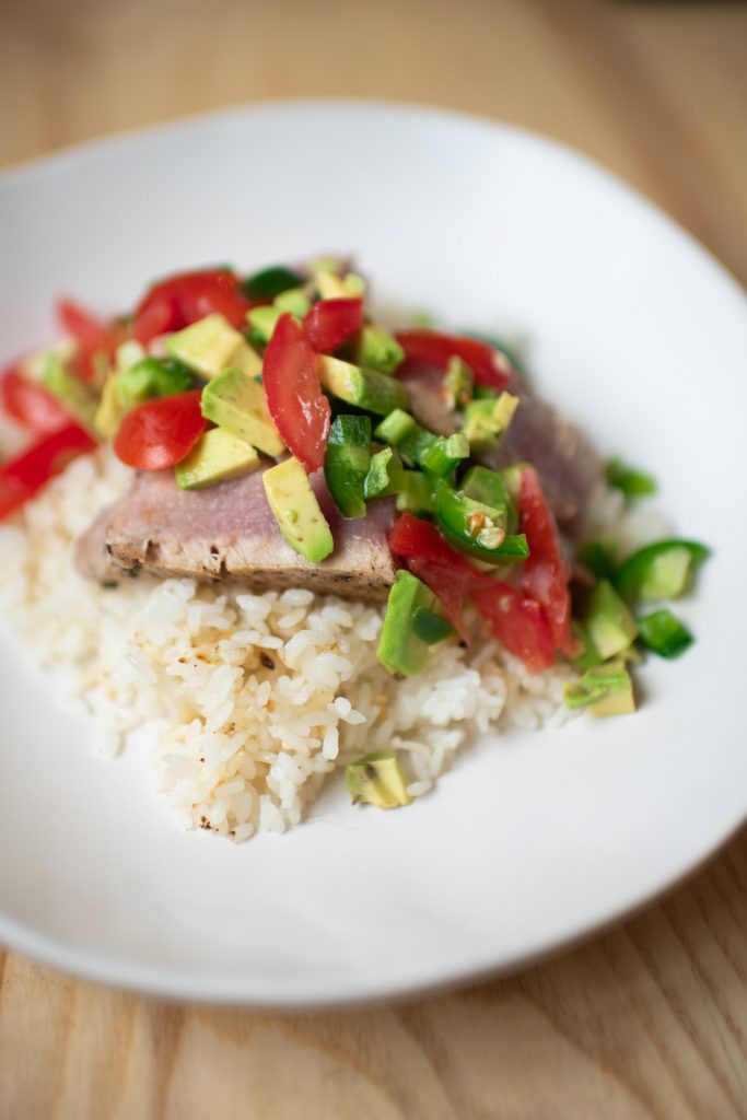 tuna steaks served over rice with jalapeno tomato and avocado salsa