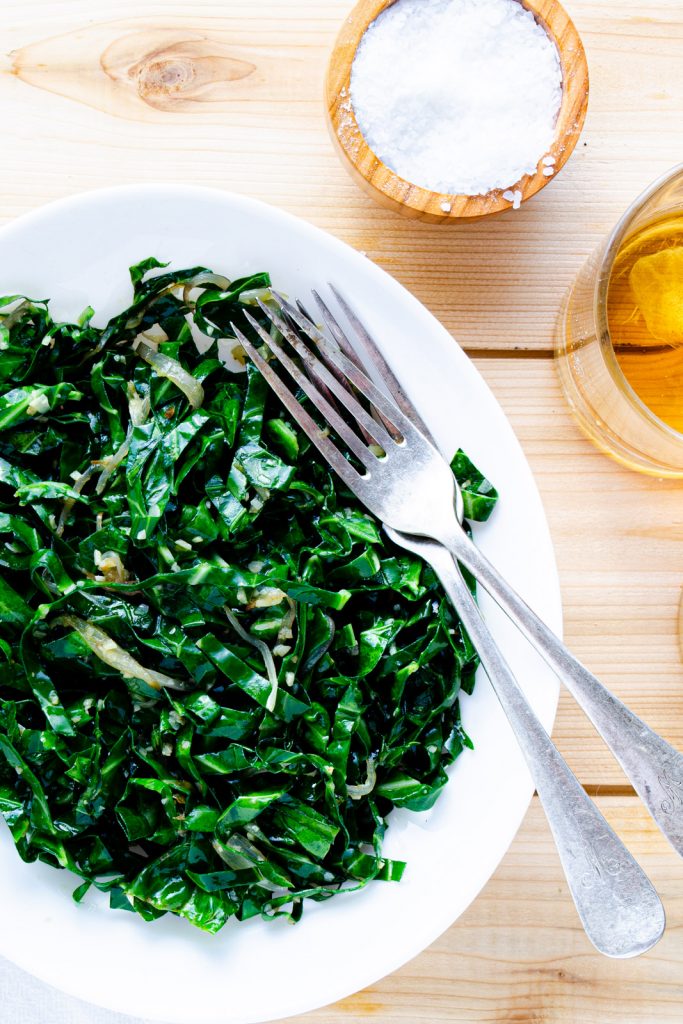 sautéed collard greens with garlic and shallot served on a plate