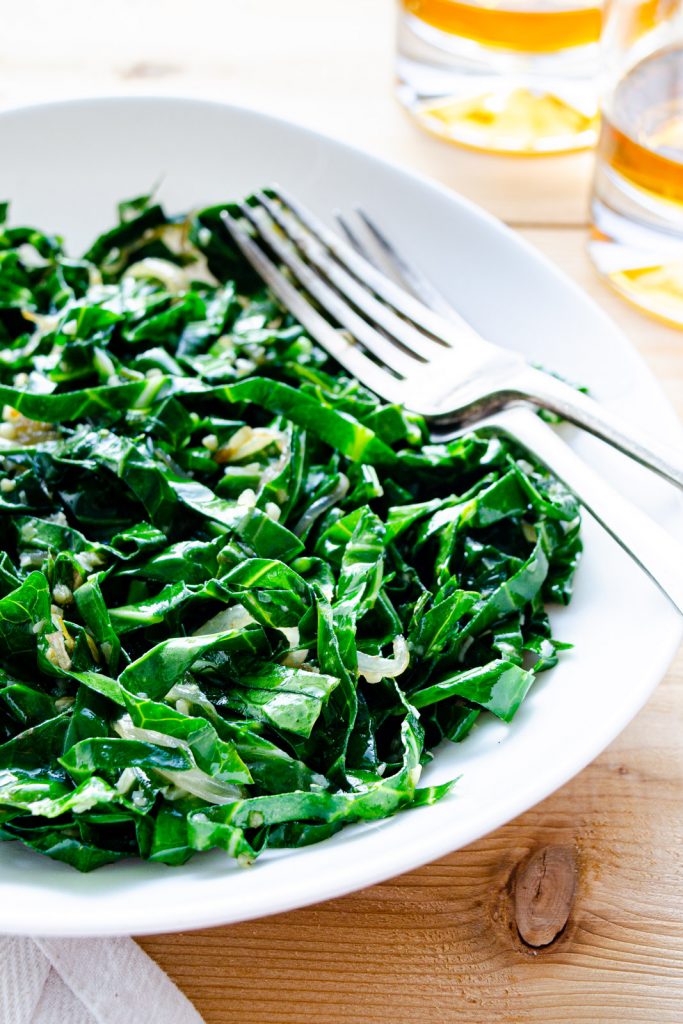 collard greens cooked with garlic and shallot on a plate