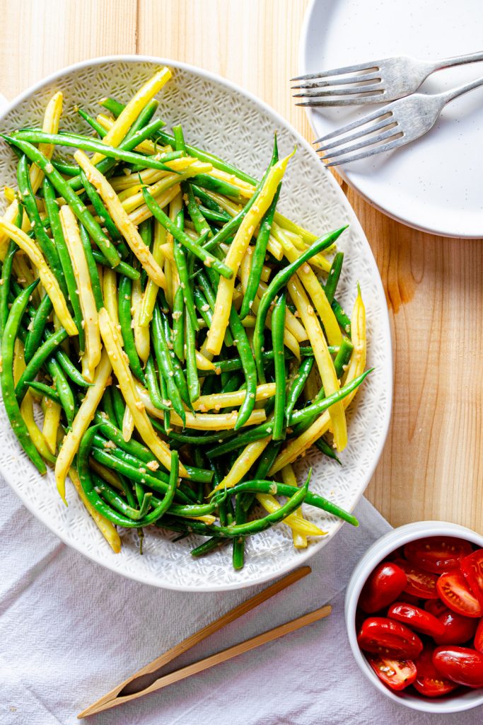 green and yellow bean salad on a platter with garlic vinaigrette