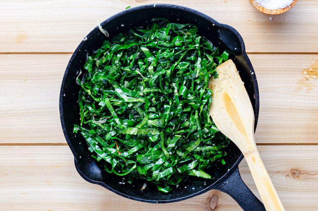 sautéed collard greens in cast iron skillet