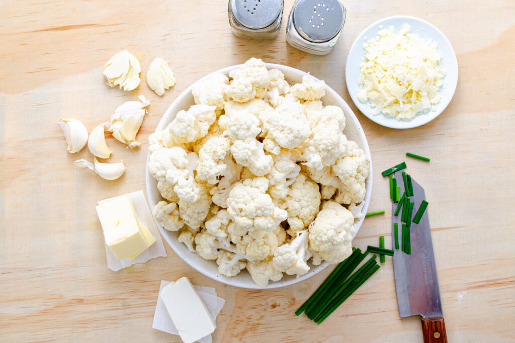 cauliflower florets, butter, garlic cloves, chives, cream cheese, and grana Padano