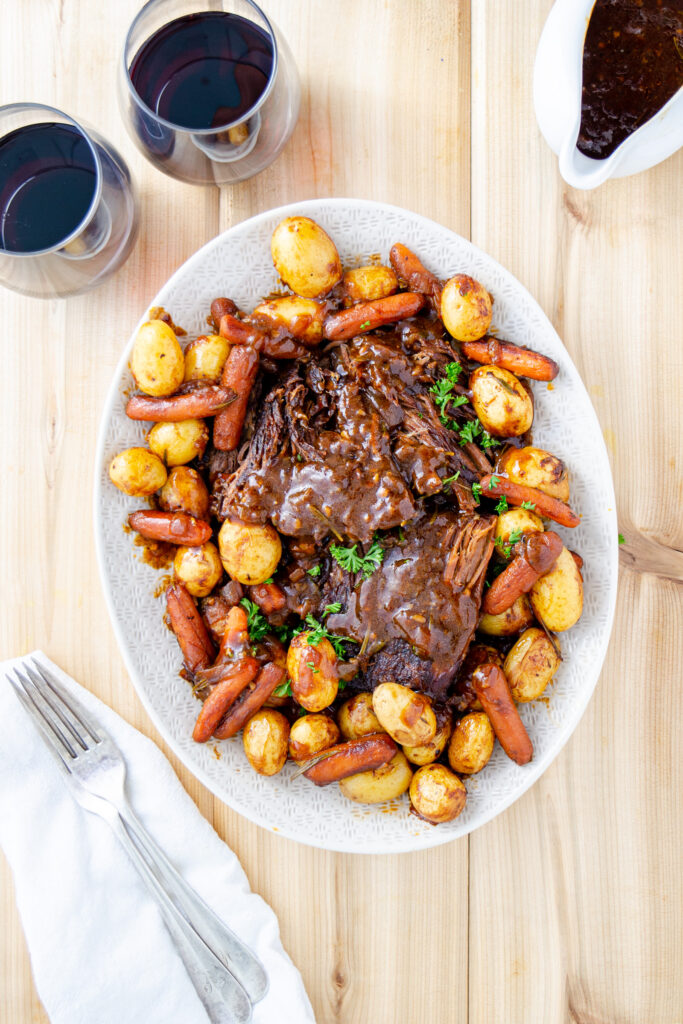 Pot roast on a platter with gravy thickened with cornstarch