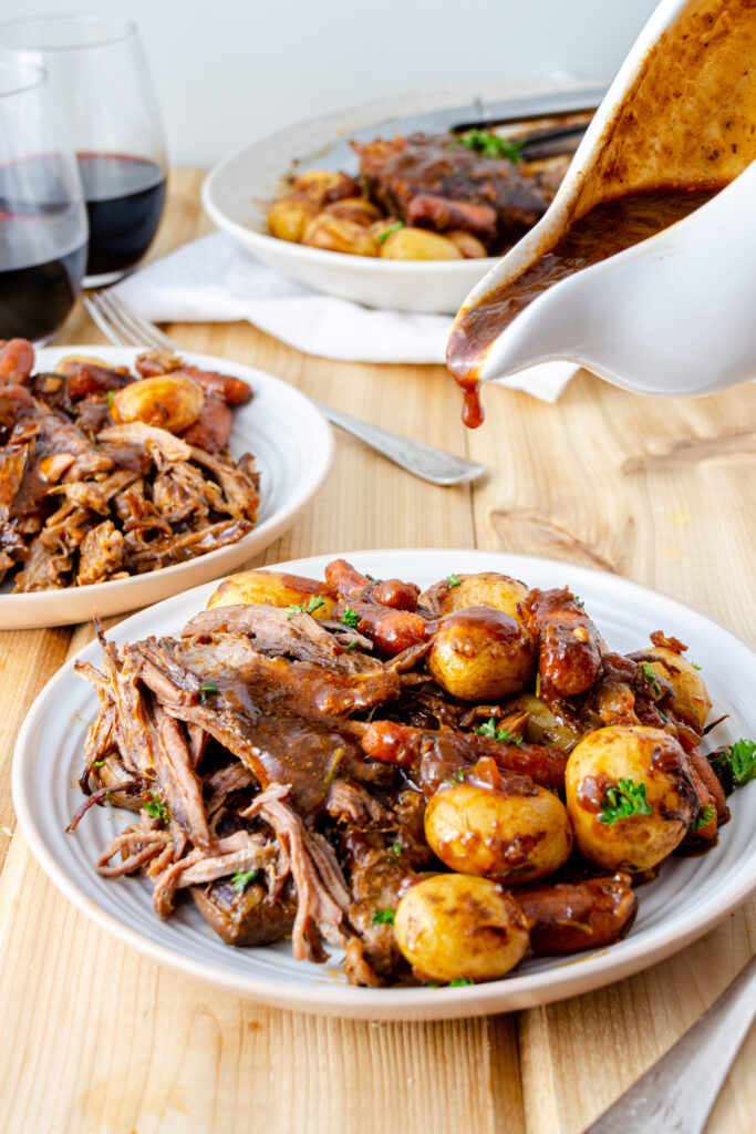 London broil pot roast with brown gravy, carrots, and potatoes