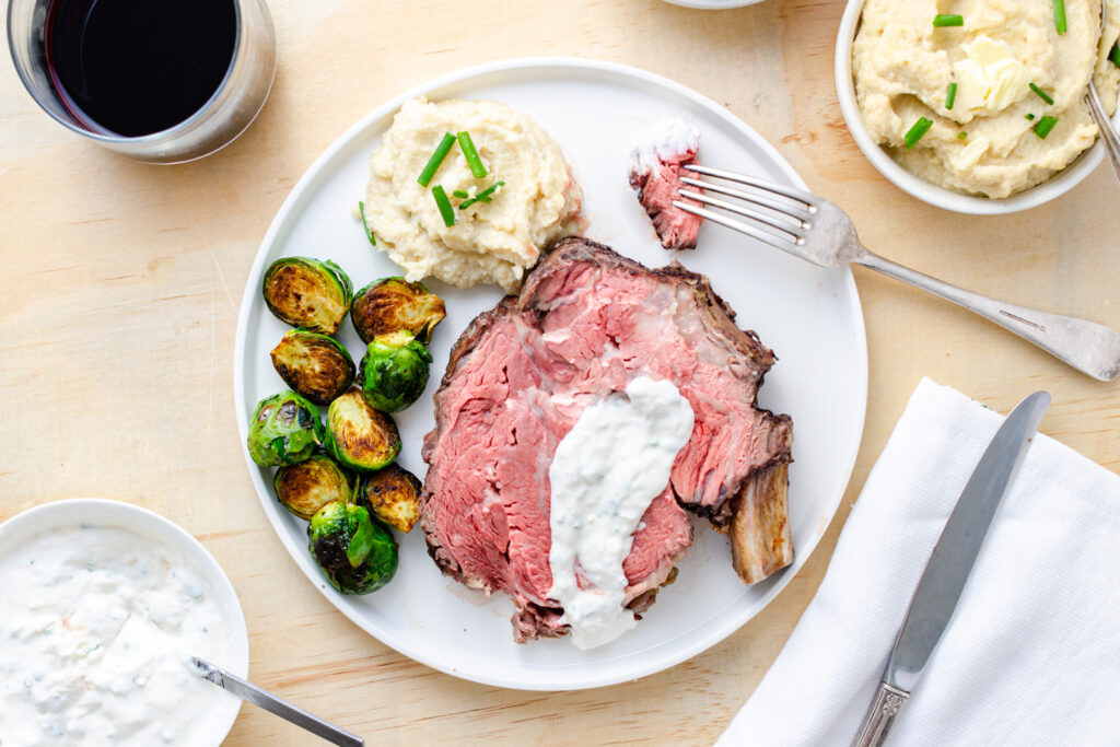 https://thefrayedapron.com/wp-content/uploads/2023/04/Prime-Rib-Roast-with-Horseradish-Sauce-Plated-with-Brussels-Sprouts-and-Cauliflower-Mash-Horizontal-1024x683.jpg