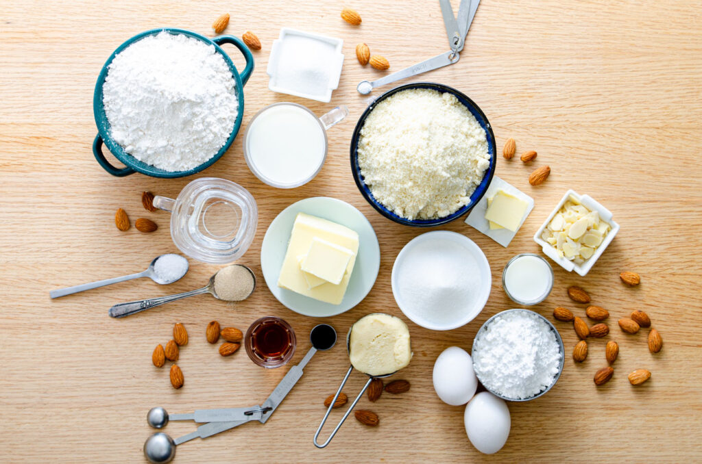 Bear claw ingredients: almond paste, flour, milk, yeast, butter salt, sugar, almond extract, almond liqueur, powdered sugar, and slivered almonds