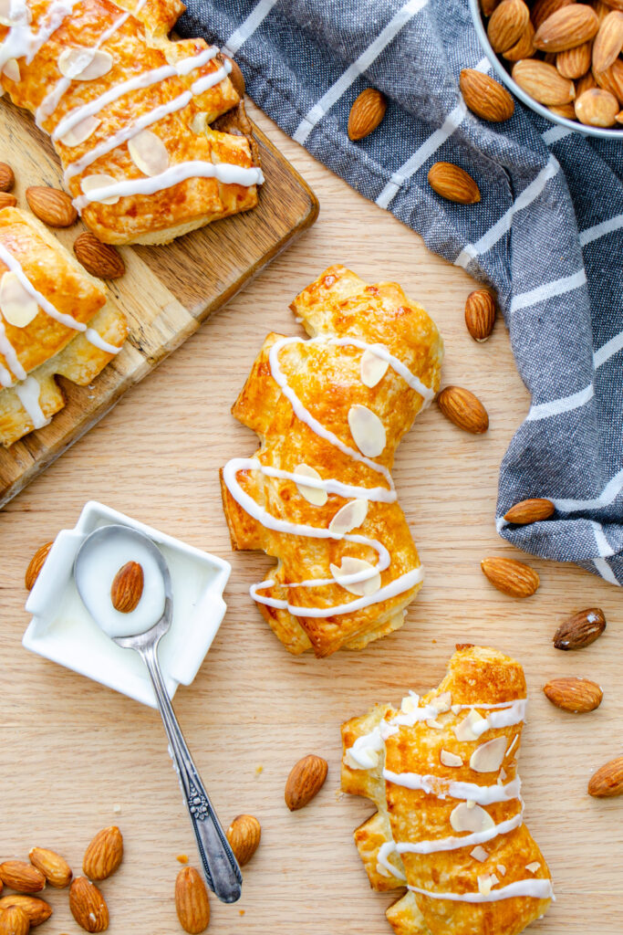 Almond bear claws topped with icing and slivered almonds