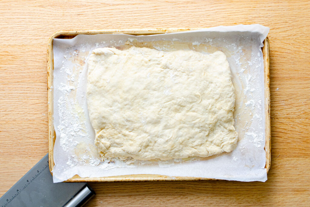 pastry dough on parchment paper resting