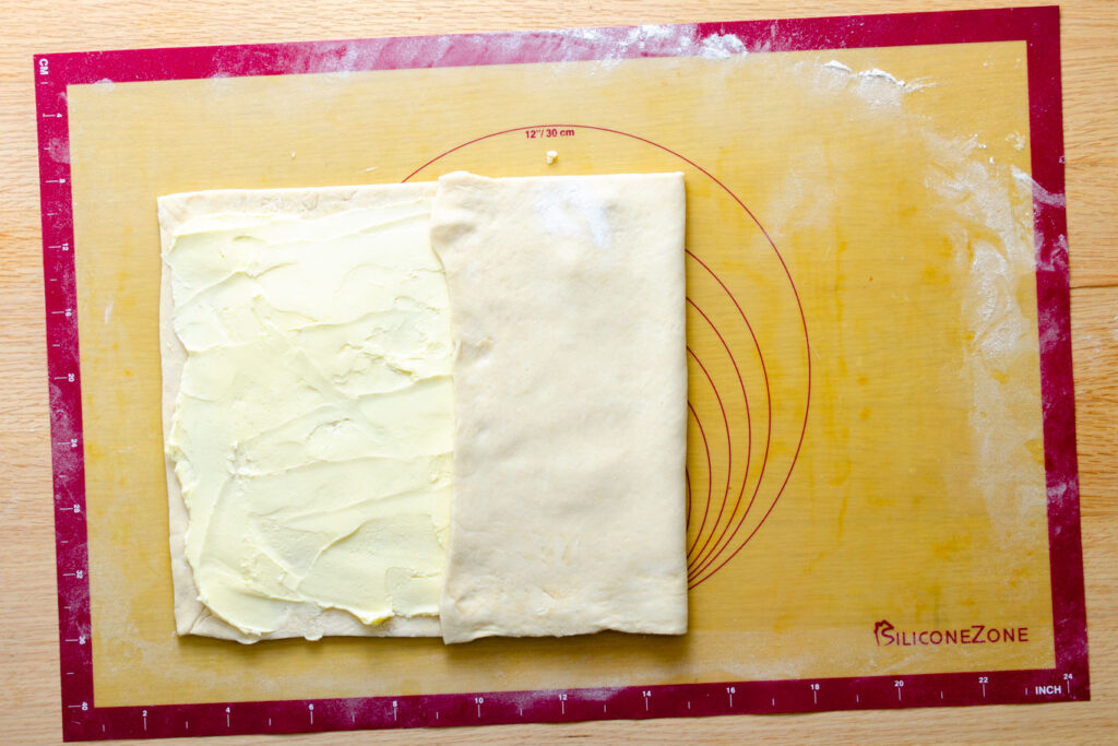 butter smeared on top of yeasted pastry dough