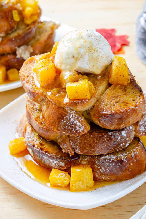 French toast with pumpkin plated with cream and maple syrup