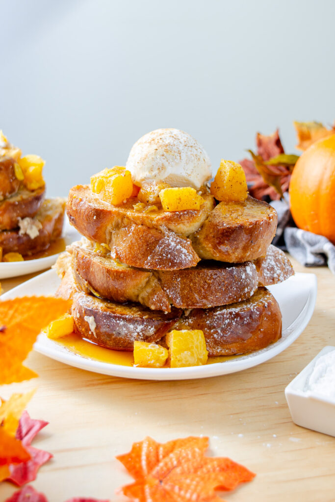 French toast casserole served with fresh pumpkin, cream, and maple syrup