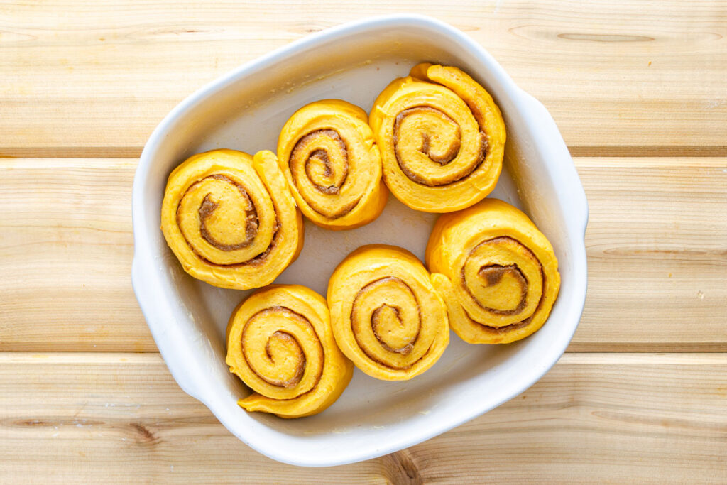pumpkin cinnamon rolls in baking dish