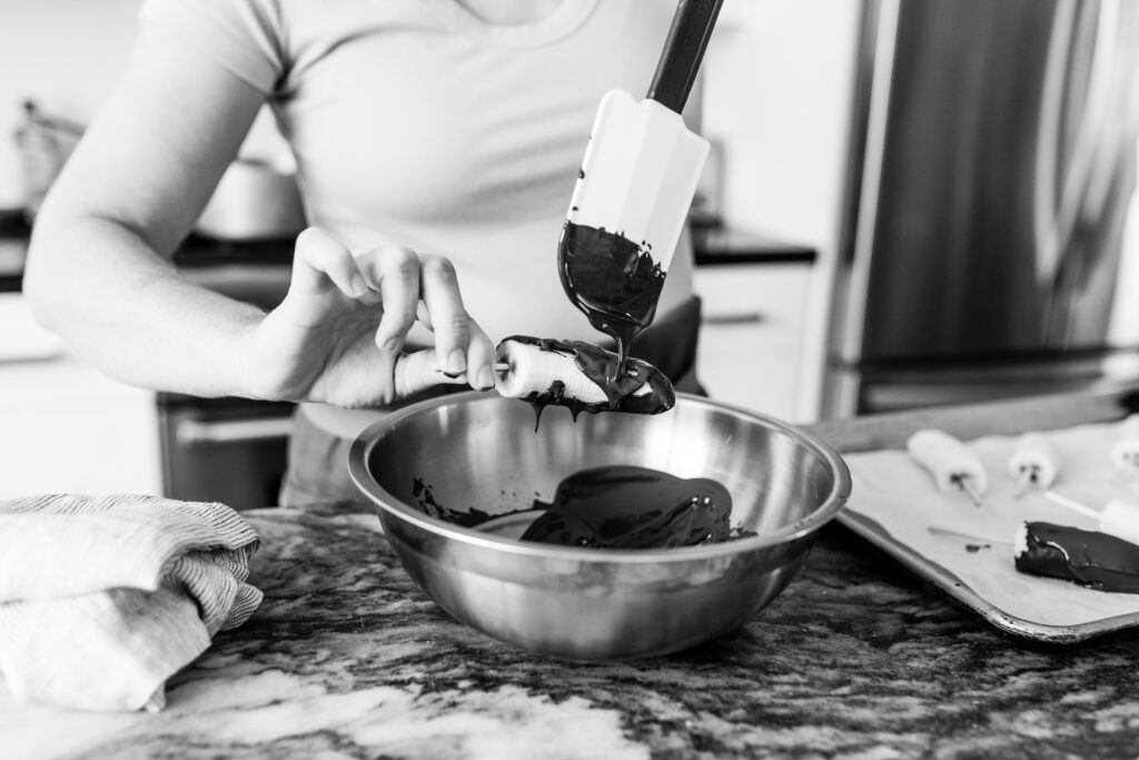 banana getting coated in melted chocolate