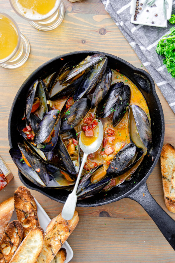 mussels braised in beer with tomato and salami