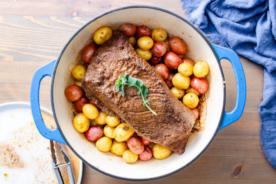 baked brisket with crust over potatoes