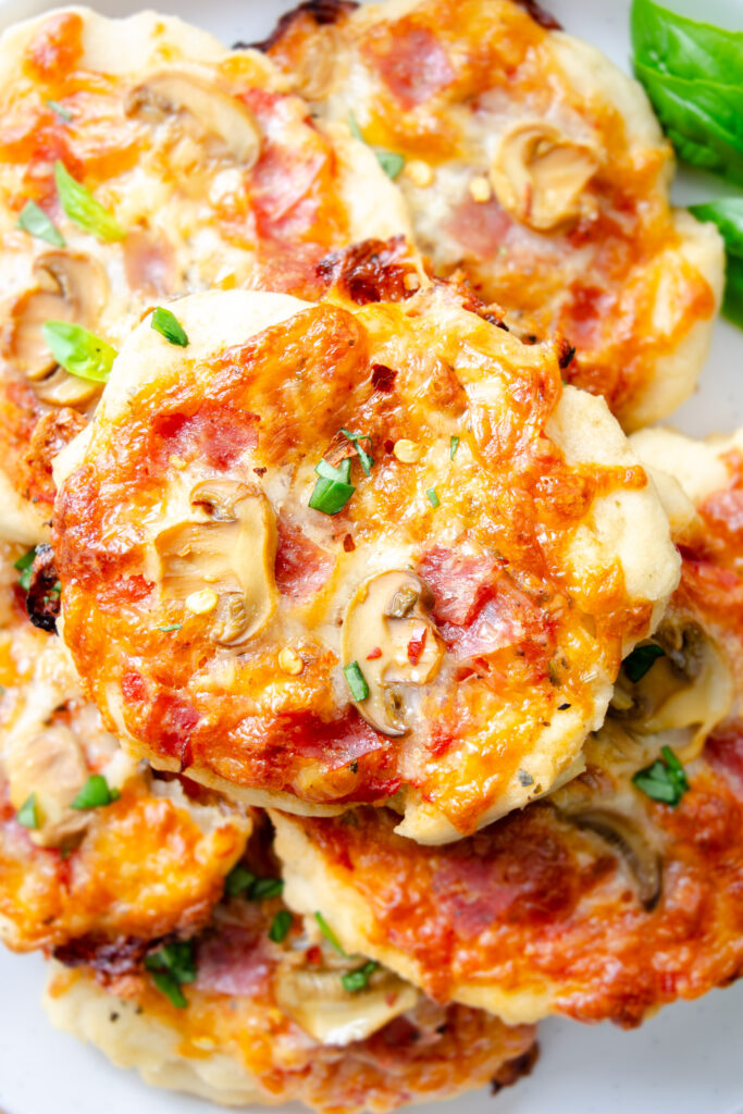 gluten-free crust pizzas with salami, mushrooms, and basil