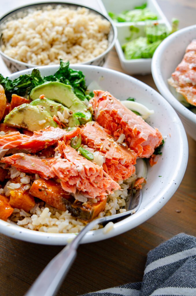baked salmon with veggies in bowl