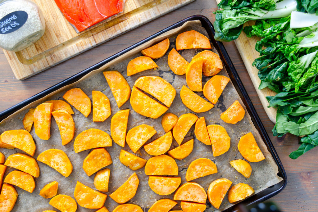 partially cooked sweet potatoes on sheet tray