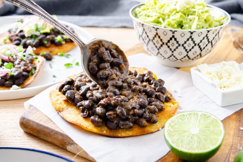 black beans with chipotle spread on crispy corn tortilla