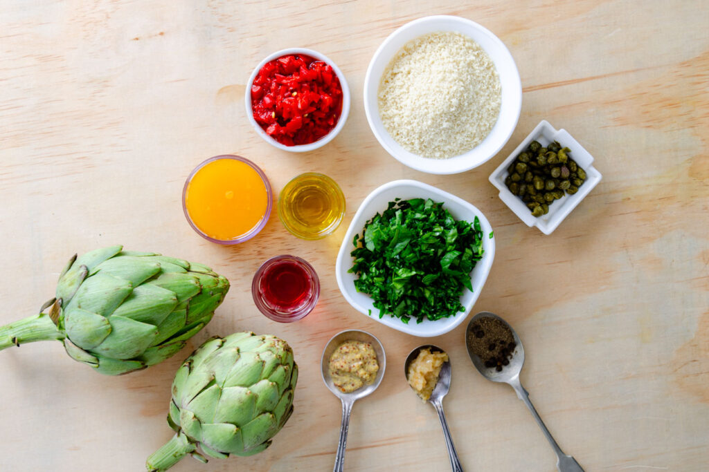 orange juice, roasted bell pepper, breadcrumbs, whole fresh artichokes, red wine vinegar, mustard, parsley, capers