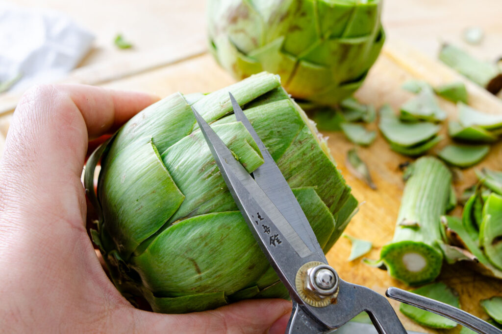 removing sharp artichoke tips with scissors