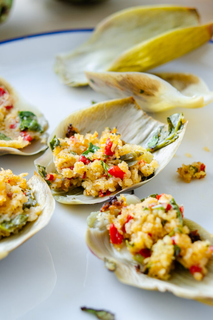 artichoke petals served on a plate with breadcrumb filling